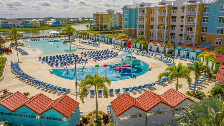 The Embassy Suites by Hilton Orlando Sunset Walk pool and children’s splash pad surrounded by pool chairs