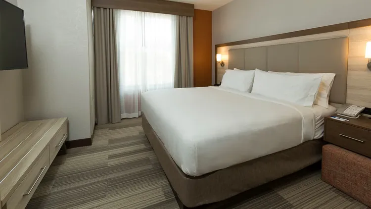A hotel room featuring a king size bed and flat-screen television