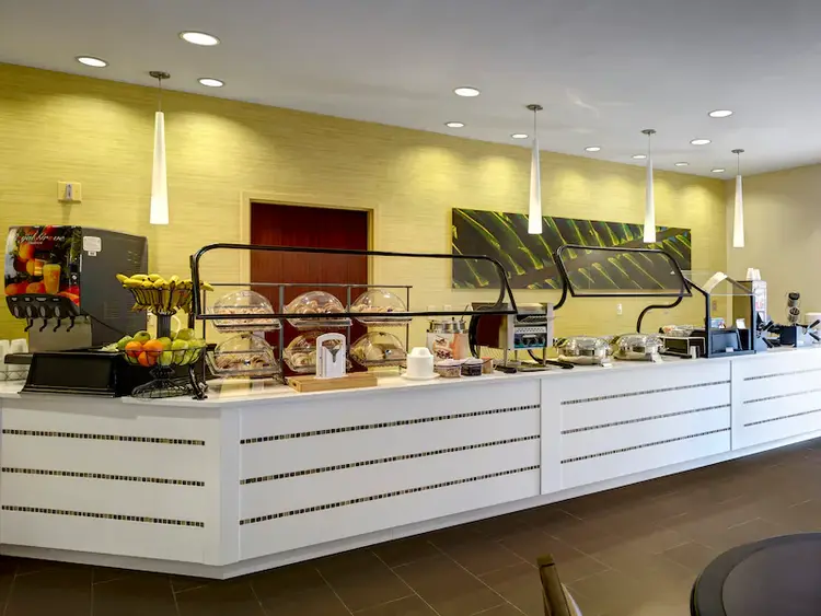 A long buffet counter filled with breakfast foods