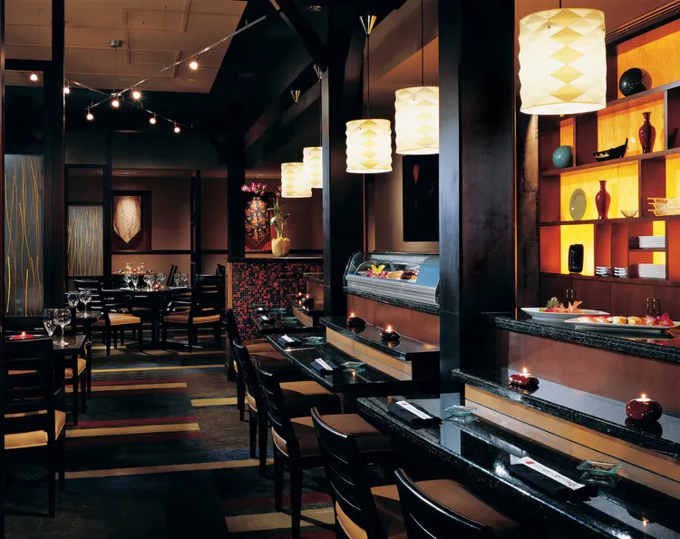 The inside of Zen restaurant featuring a sushi bar, tables and chairs