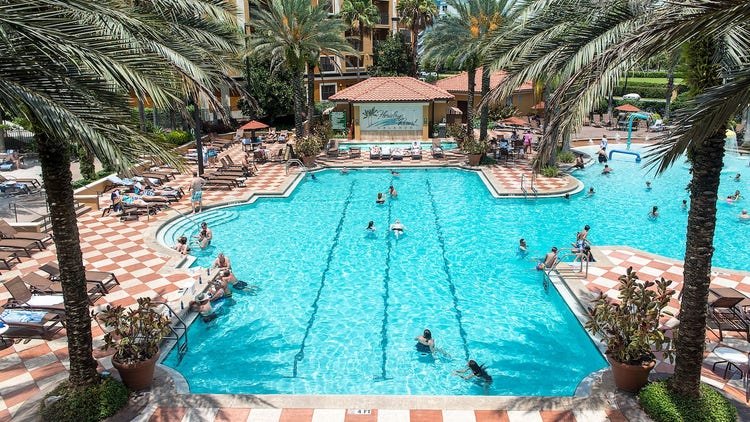 Swimmers and sunbathers enjoying a hotel pool
