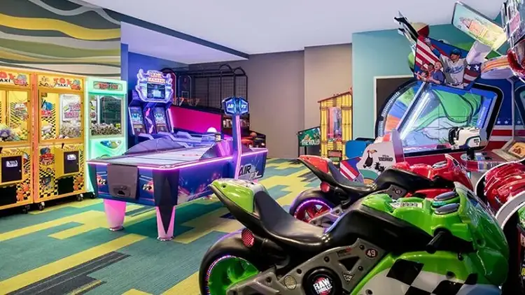 An arcade room featuring various games including table hockey