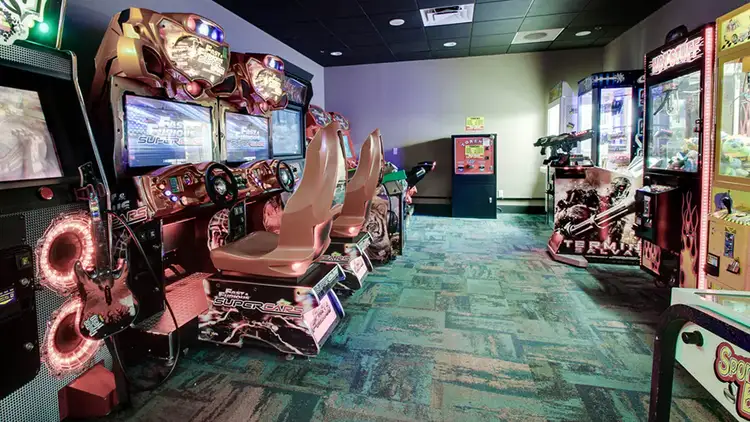 An arcade featuring various games including driving simulations and a claw machine