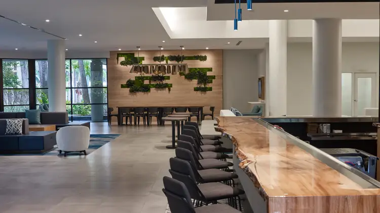 A long bar extends down a hotel lobby