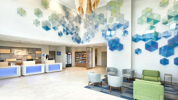 The hotel lobby featuring the check-in counter, seating area and modern decor