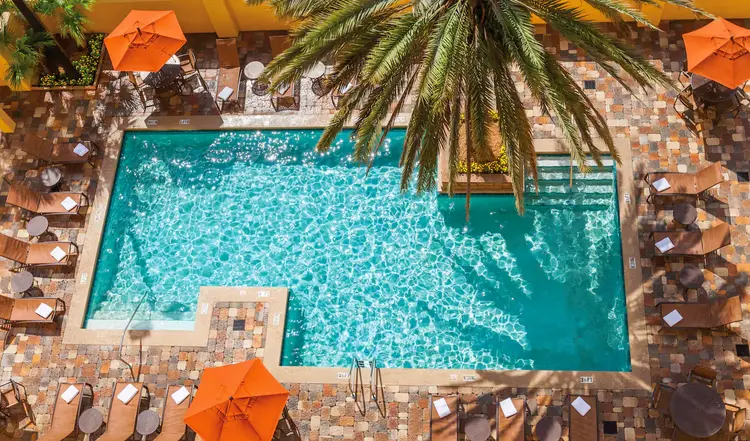 An outdoor pool with lounge chairs around the water
