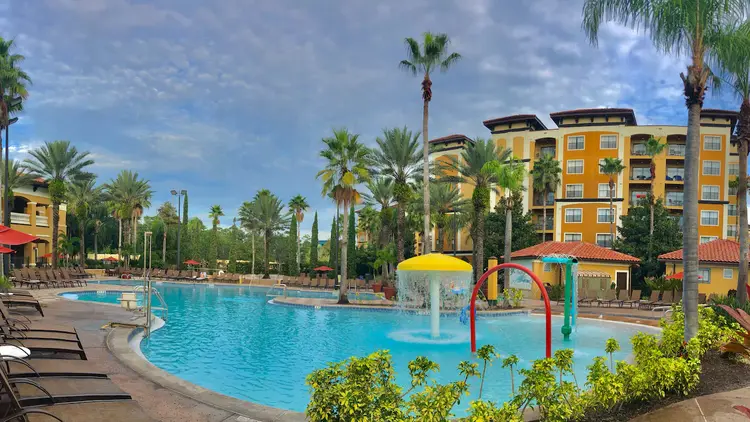 A hotel swimming pool with a kids’ water play area