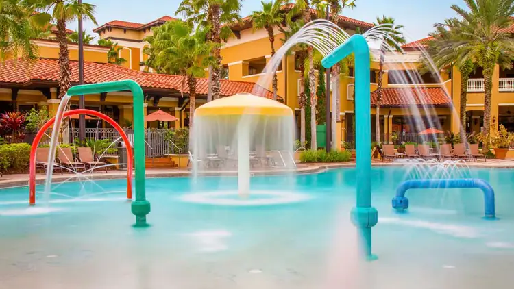 Water flowing, jetting, streaming and gushing from various equipment in a swimming pool play area