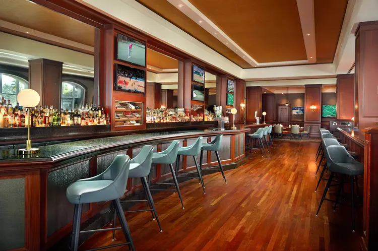 The inside of David’s Club restaurant featuring a long bars and chairs